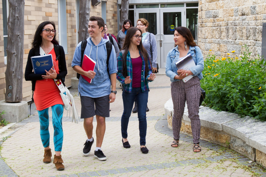 Four Indigenous students walking on campus.